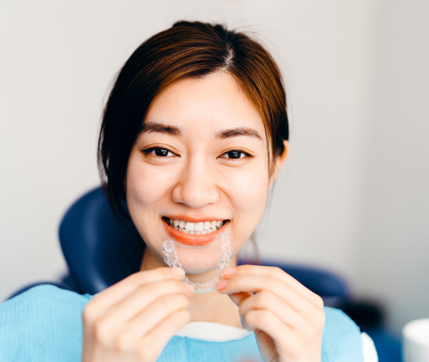 woman putting in clear aligner